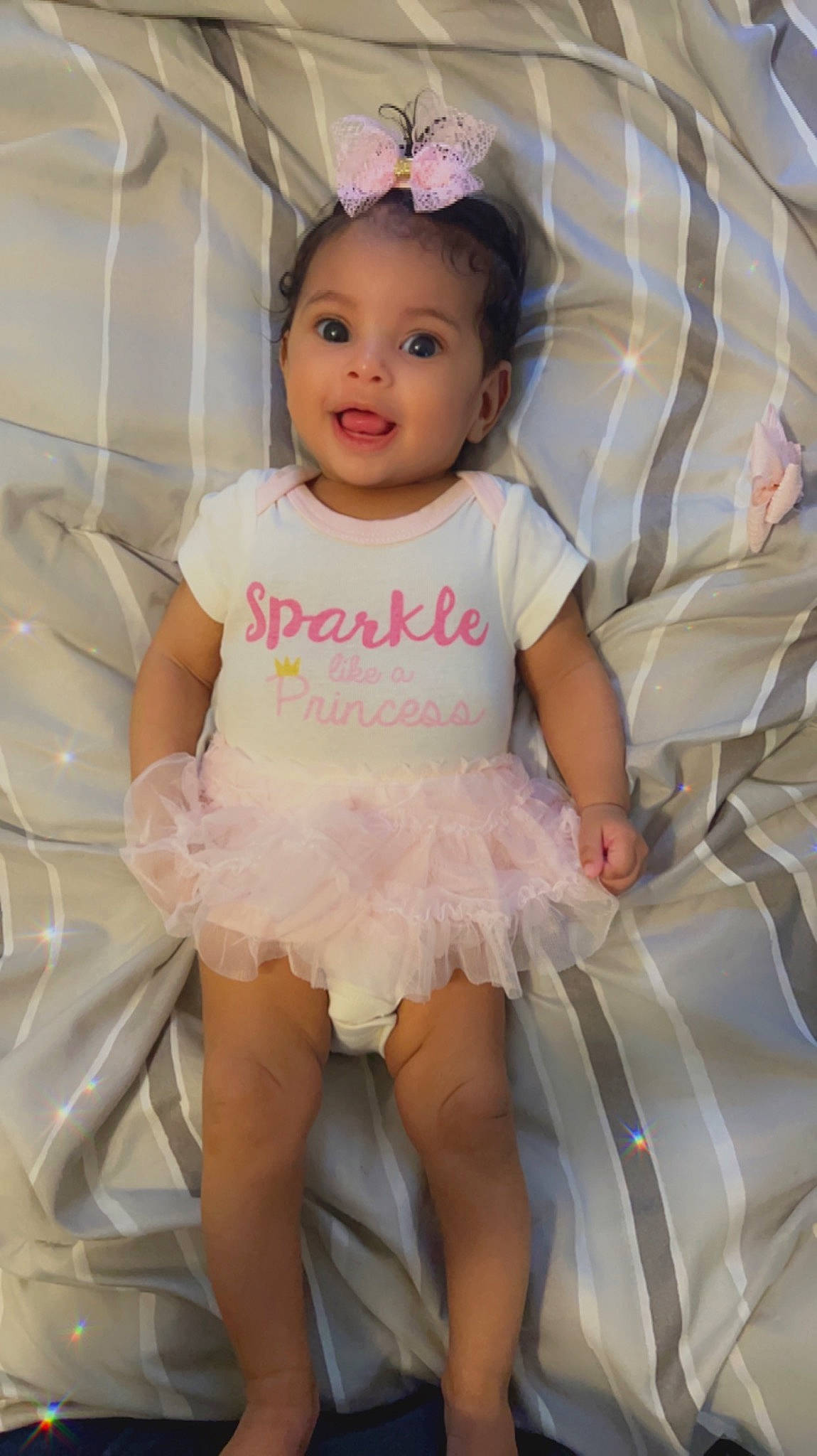 Amira joined the competition — help win amazing prizes! baby_toddler_clothing, day_dress, dress, embellishment, face, fashion, happy, head, headpiece, iris, magenta, pattern, person, pink, ruffle, skin, sleeve, smile, textile, toddler