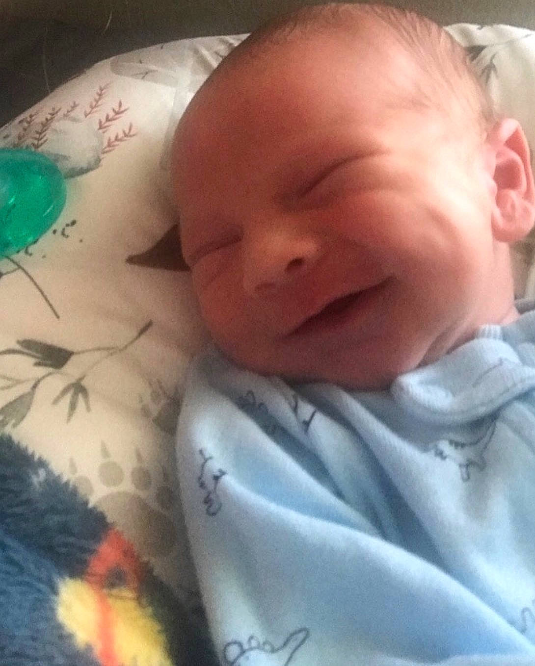 Lukus is registered to the contest to win money with this photo: baby, baby_toddler_clothing, bedtime, cheek, child, comfort, eyebrow, finger, grass, happy, iris, linens, mouth, nose, pattern, person, skin, smile, textile, thumb