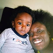 Quentin is registered to the contest to win money with this photo: child, toddler, adult, smile, face, indoor, portrait, hair, clothing, love, expression, closeup, person, happy, candid, casual, family, skin, head, sitting