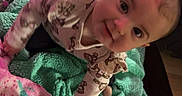 Tiana joined the competition — help win amazing prizes! baby, infant, child, blanket, pink_blanket, green_blanket, toy, toys, floor, cute, smiling, playful, indoors, person, clothing, long_sleeve, patterned_clothing, face, head, bright_colors