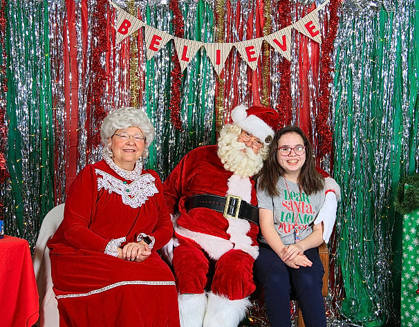 Liberty is registered to the contest to win money with this photo: christmas, christmas_decoration, christmas_eve, christmas_ornament, decoration, event, facial_expression, fun, green, happy, holiday, human, human_body, joy, lap, leisure, person, red, smile, standing