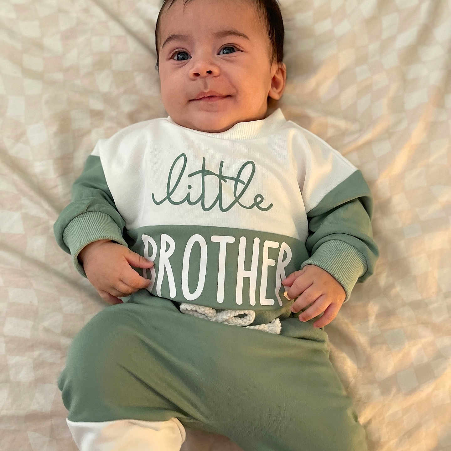 Draven is registered to the contest to win money with this photo: baby, bodypart, clothing, cushion, face, finger, hand, happy, head, homedecor, longsleeve, newborn, pants, person, photography, portrait, sitting, sleeve, smile, t_shirt