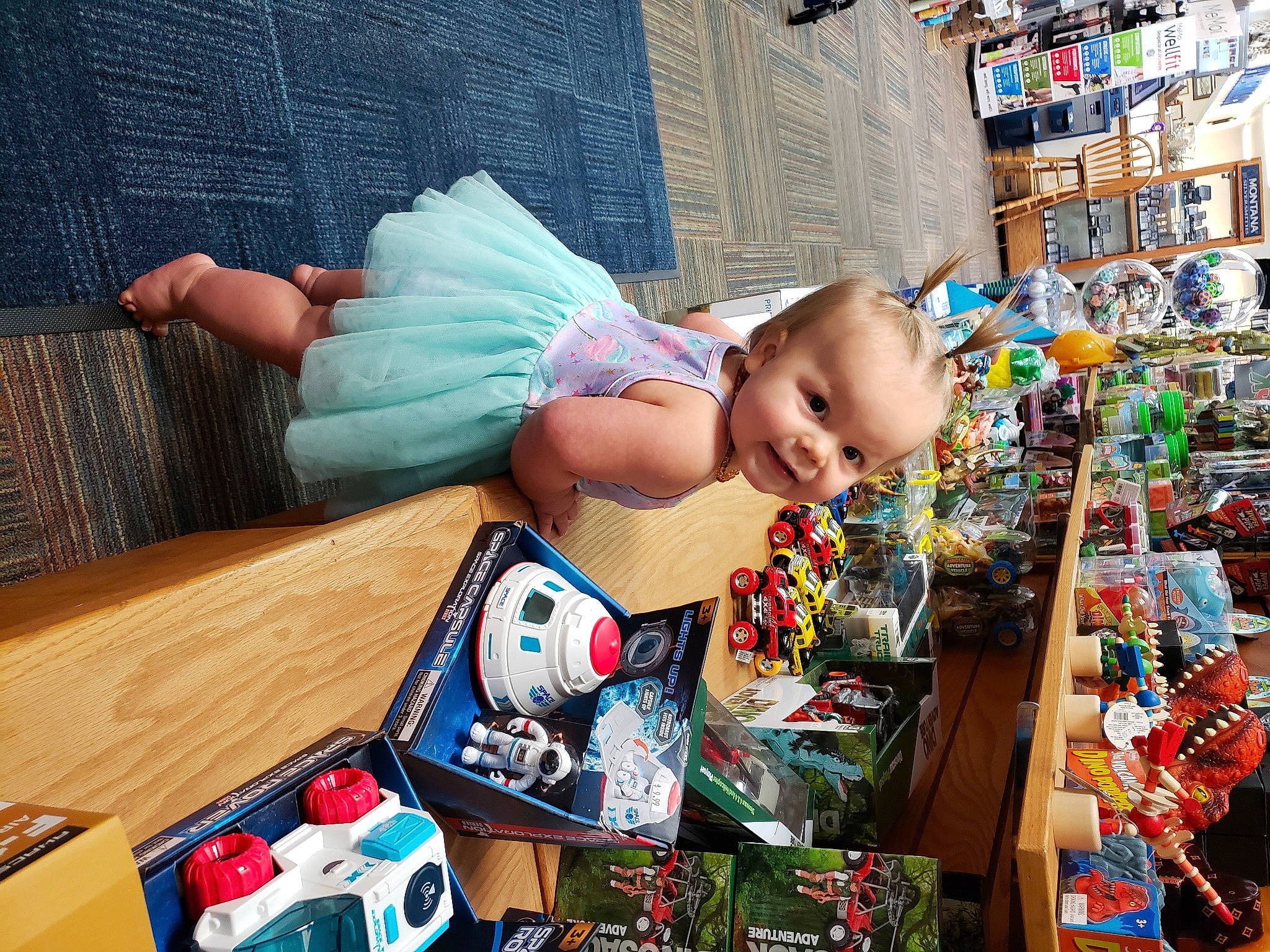 Jemma is registered to the contest to win money with this photo: art, baby, baby_products, baby_toddler_clothing, child, event, fun, happy, holiday, leisure, person, play, product, remote_control, room, sitting, smile, table, toddler, toy