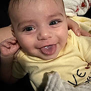 Hunter joined the competition — help win amazing prizes! baby, infant, smiling, tongue_out, close_up, portrait, onesie, yellow_clothing, blanket, hand, parent_hand, eyes, eyelashes, hair, face, happy, cute, indoor, soft_texture, skin