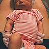 baby, newborn, sleeping, infant, pink_onesie, headband, bow, mittens, legs, feet, adult_legs, skin, cute, peaceful, resting, portrait, indoors, human, closeup, soft_lighting