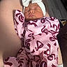 Nova joined the competition — help win amazing prizes! newborn, baby, sleeping, headband, bow, onesie, pink_clothing, maroon_pattern, infant, person, arm, skin, resting, cozy, cute, indoors, portrait, child, soft_lighting, peaceful