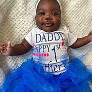 Love is registered to the contest to win money with this photo: accessories, baby, bodypart, clothing, dress, face, finger, formalwear, hand, happy, hat, head, jewelry, necklace, person, photography, portrait, sitting, smile, t_shirt