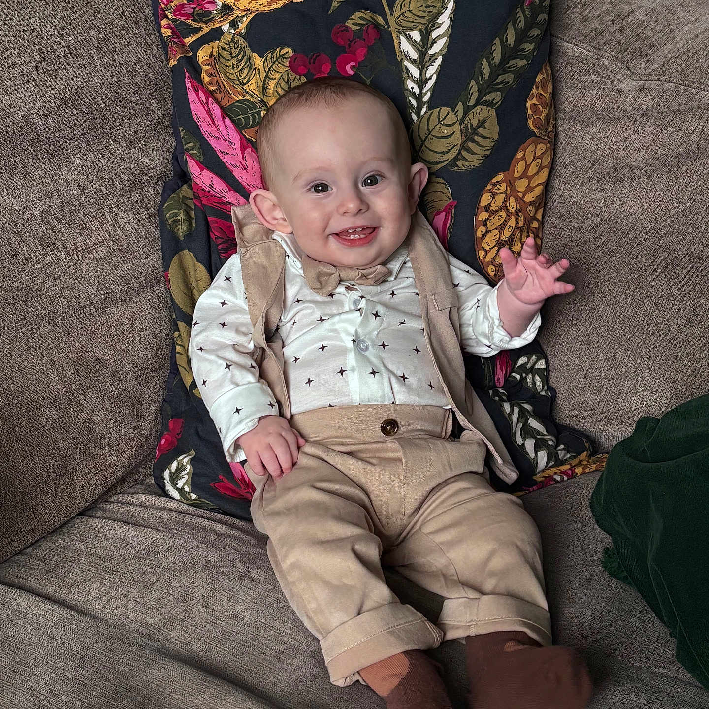 Blake is registered to the contest to win money with this photo: baby, bow_tie, child, clothing, couch, cute, face, hand, happy, home, indoor, infant, pants, person, pillow, portrait, shirt, sitting, smiling, sock