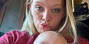 Jaxon is registered to the contest to win money with this photo: woman, baby, indoor, selfie, pout, face, blonde_hair, blue_eyes, casual_clothing, cartoon_shirt, red_shirt, door, pipe, expression, portrait, person, child, skin, head, closeup