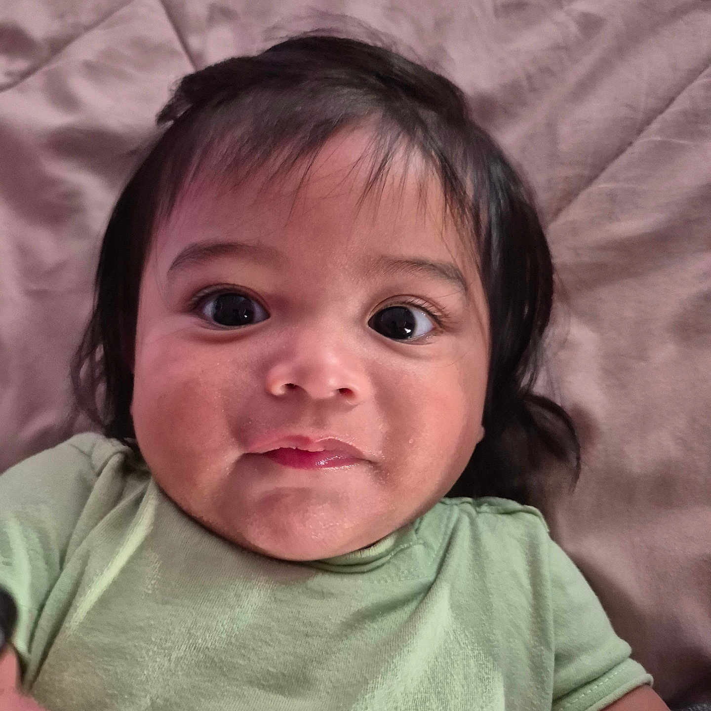 Elliot Contreras joined the competition — help win amazing prizes! baby, child, closeup, clothing, cute, expression, eyes, face, green_shirt, hair, head, indoors, infant, lying_down, mouth, person, portrait, skin, soft_background, young