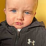 Ayden a rejoint le concours — aidez-le/la à gagner de superbes lots ! baby, baby_face, black_jacket, blue_eyes, child, close_up, clothing, cute, expression, face, head, indoors, person, portrait, pout, skin, under_armour, yellow_background, young_child, zipper