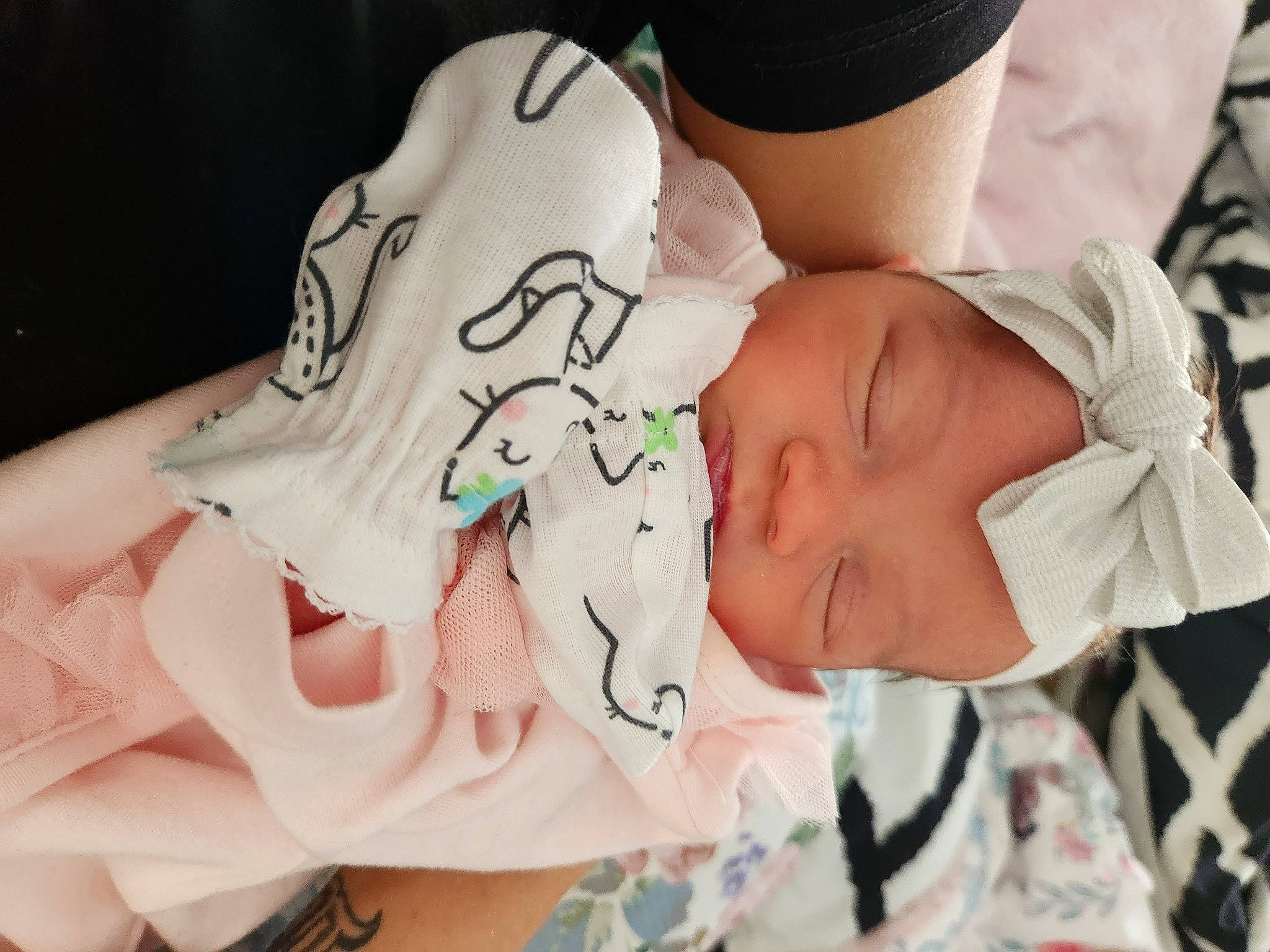 Sienna is registered to the contest to win money with this photo: arm, baby, baby_products, baby_sleeping, baby_toddler_clothing, carmine, cheek, child, comfort, event, eyelash, finger, happy, headgear, headwear, nail, pattern, person, skin, textile