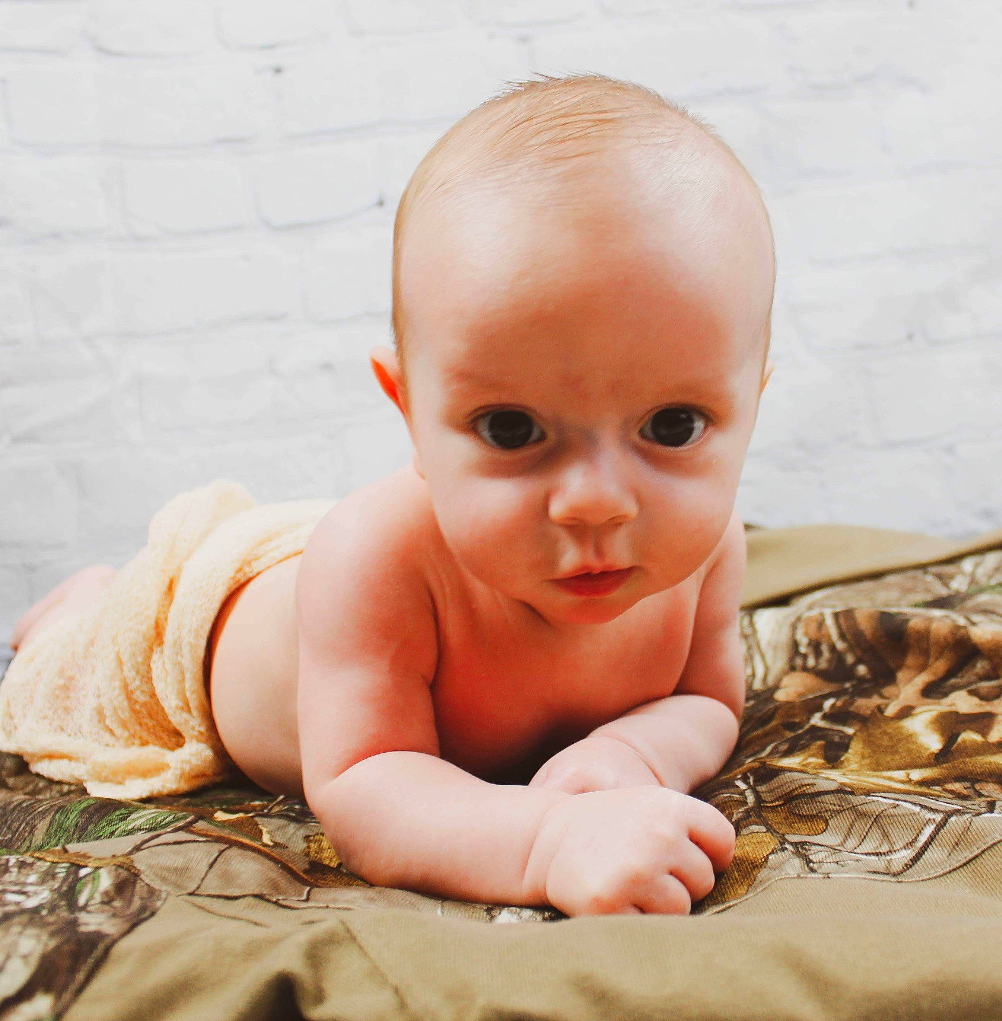 Gaige is registered to the contest to win money with this photo: baby, cheek, child, eye, face, finger, hand, head, lip, mouth, nose, person, photography, portrait_photography, skin, smile, toddler, tummy_time