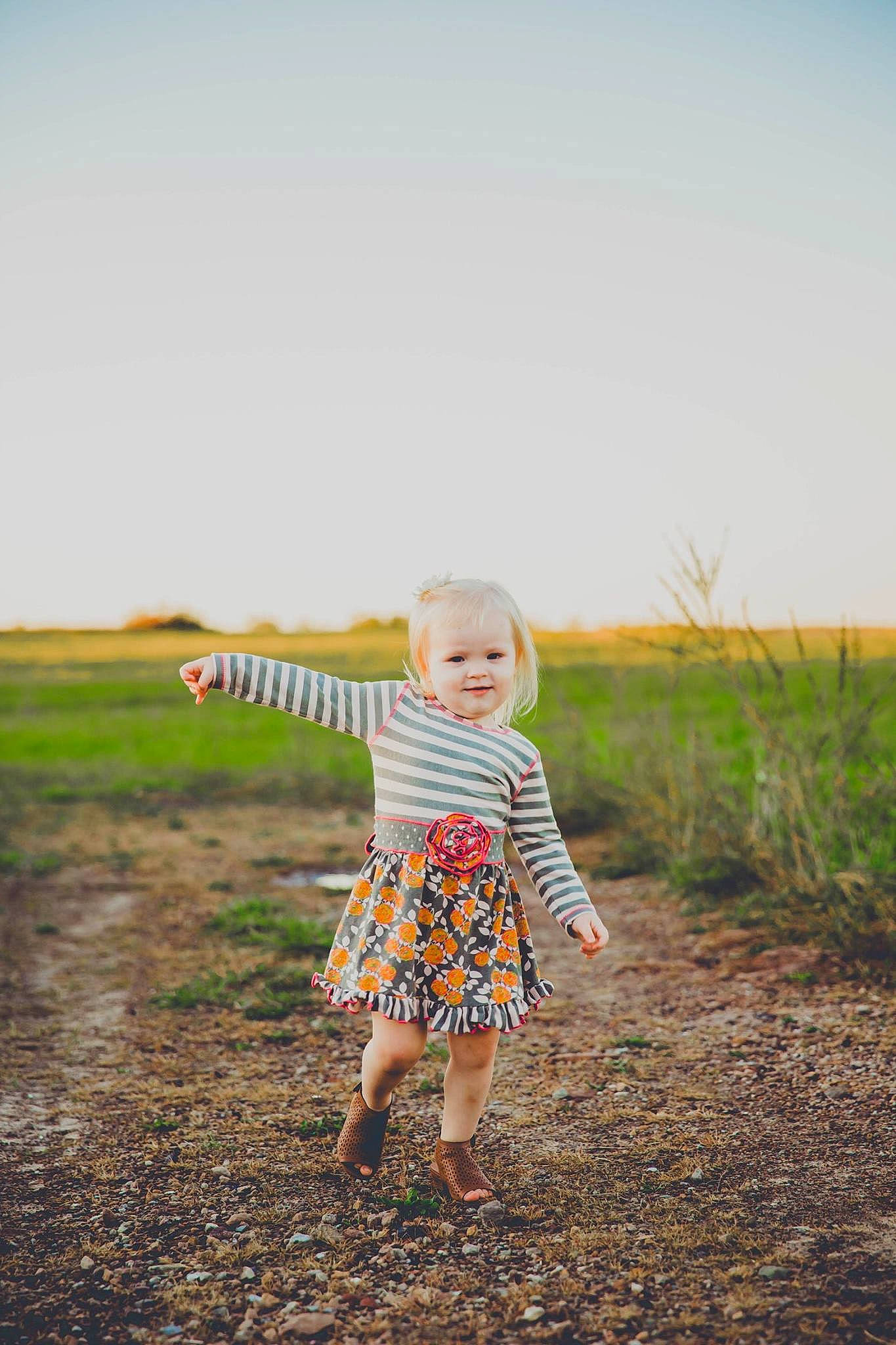 Taylor is registered to the contest to win money with this photo: child, dress, field, fun, grass, grass_family, grassland, happy, joy, people, people_in_nature, person, photograph, photography, portrait_photography, skin, sky, smile, standing, summer