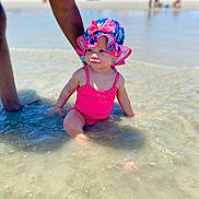 Kehlani joined the competition — help win amazing prizes! baby, child, swimsuit, sunhat, water, beach, tattoo, arm, sand, sea, summer, vacation, sunny, outdoor, people, colorful, sitting, shallow_water, portrait, curious