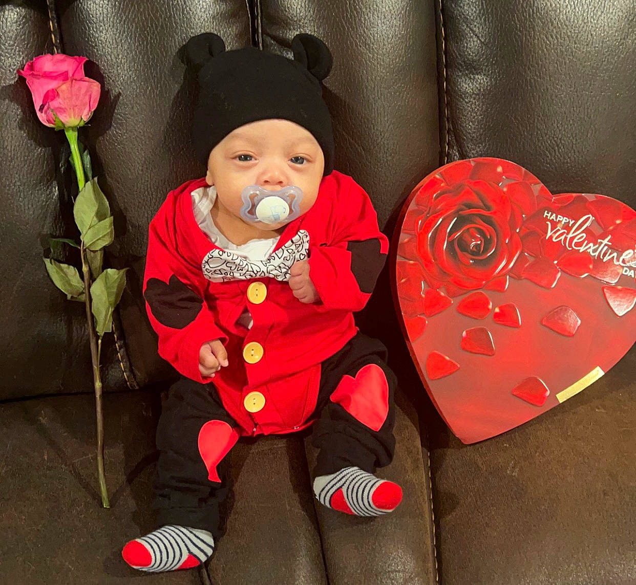 Donovan joined the competition — help win amazing prizes! baby, baby_toddler_clothing, cap, carmine, costume_hat, event, flower, happy, hat, headwear, holiday, human_body, lap, person, pink, plant, red, rose, sleeve, sun_hat