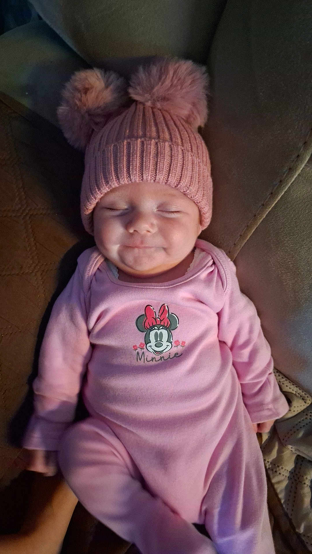 Esme-Rian joined the competition — help win amazing prizes! baby, infant, pink_clothing, hat, pom_pom, smile, closed_eyes, couch, soft_furniture, cute, sleepy, child, person, indoors, warm, cozy, resting, small, adorable, comfort