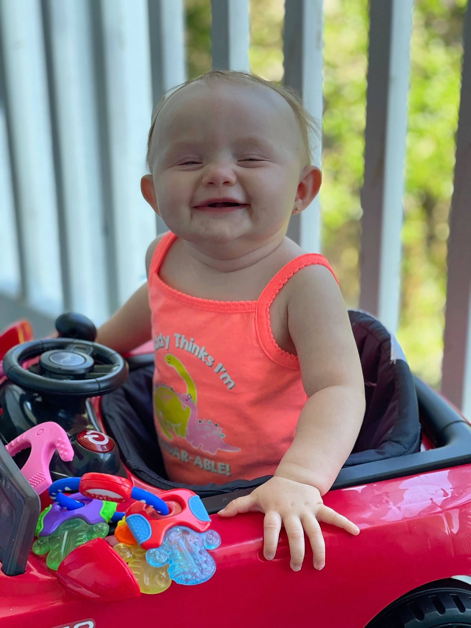 Kaisley is registered to the contest to win money with this photo: arm, baby, baby_toddler_clothing, child, eye, fun, grass, happy, input_device, leisure, person, pink, product, recreation, skin, smile, tire, toddler, toy, vehicle
