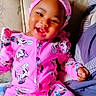 baby, bright_colors, child, couch, cozy, cute, fashion, floral_pattern, happy, headwear, indoors, minnie_mouse, person, pink_clothing, playful, portrait, sitting, smiling, toddler, young_child