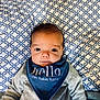 Lucien is registered to the contest to win money with this photo: accessories, baby, bed, blanket, clothing, coat, couch, cushion, face, furniture, head, headband, homedecor, jacket, people, person, photography, pillow, portrait, scarf