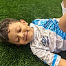 Ignacio is registered to the contest to win money with this photo: artificial_turf, boy, casual, child, cute, daylight, face, grass, happy, kid, leisure, lying_down, outdoor, portrait, recreation, short_hair, smiling, sportswear, umbro, young