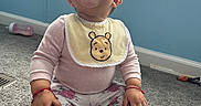 Keyri joined the competition — help win amazing prizes! baby, baby_bottle, bib, carpet, casual_clothing, child, cute, dinosaur, floor, floral_pants, happy, home, indoors, red_bracelet, sitting, smiling, toddler, toy, window, winnie_the_pooh