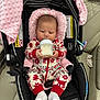 Keyri is registered to the contest to win money with this photo: baby, infant, car_seat, bottle, feeding, pajamas, red, white, pink_blanket, socks, indoor, car_interior, seat_belt, child, cute, holiday_theme, patterned_clothing, soft_texture, newborn, portrait