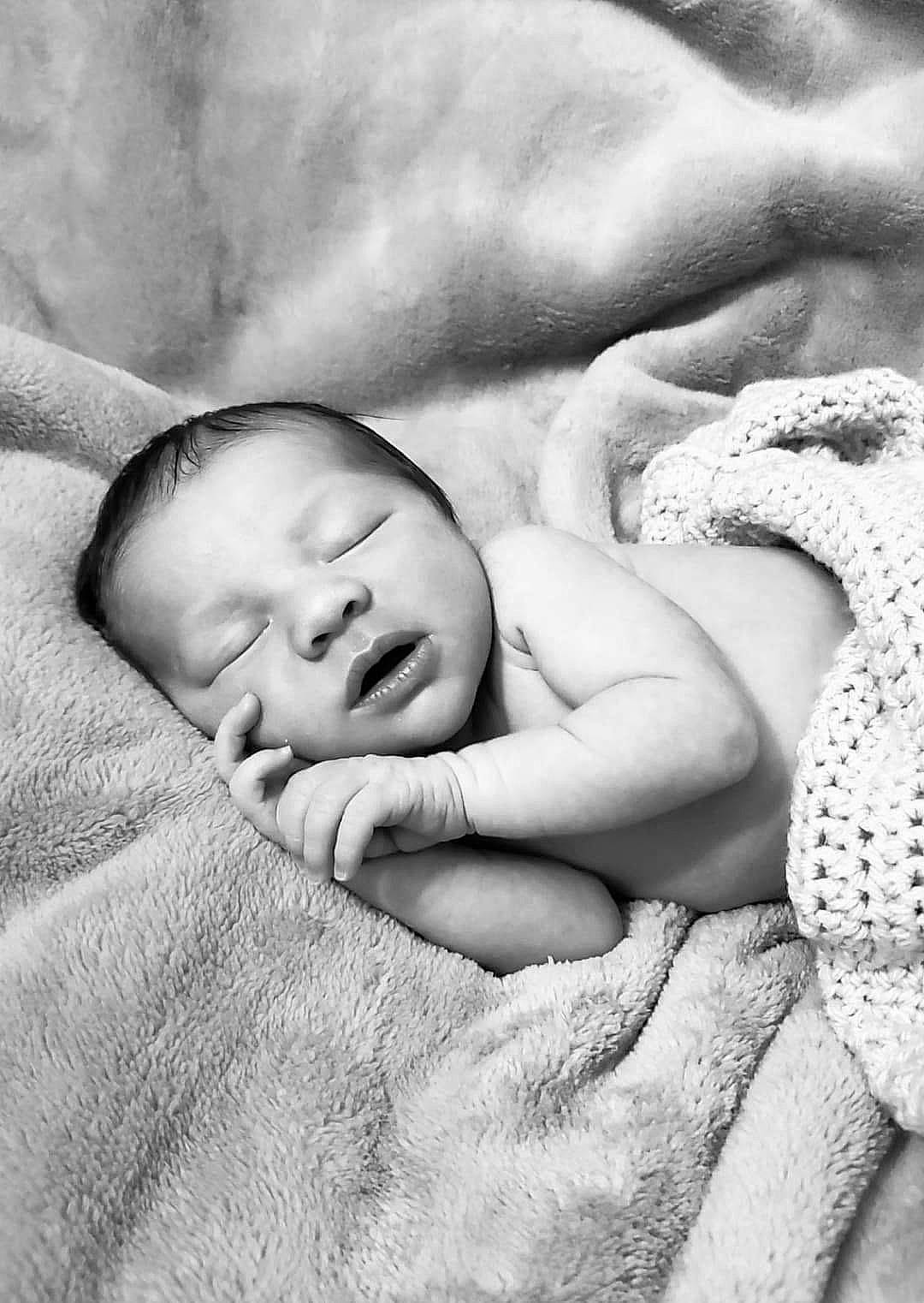 Julius is registered to the contest to win money with this photo: baby, bedtime, black_and_white, child, close_up, comfort, finger, fur, gesture, grass, grey, happy, linens, monochrome, monochrome_photography, person, product, skin, stock_photography, textile