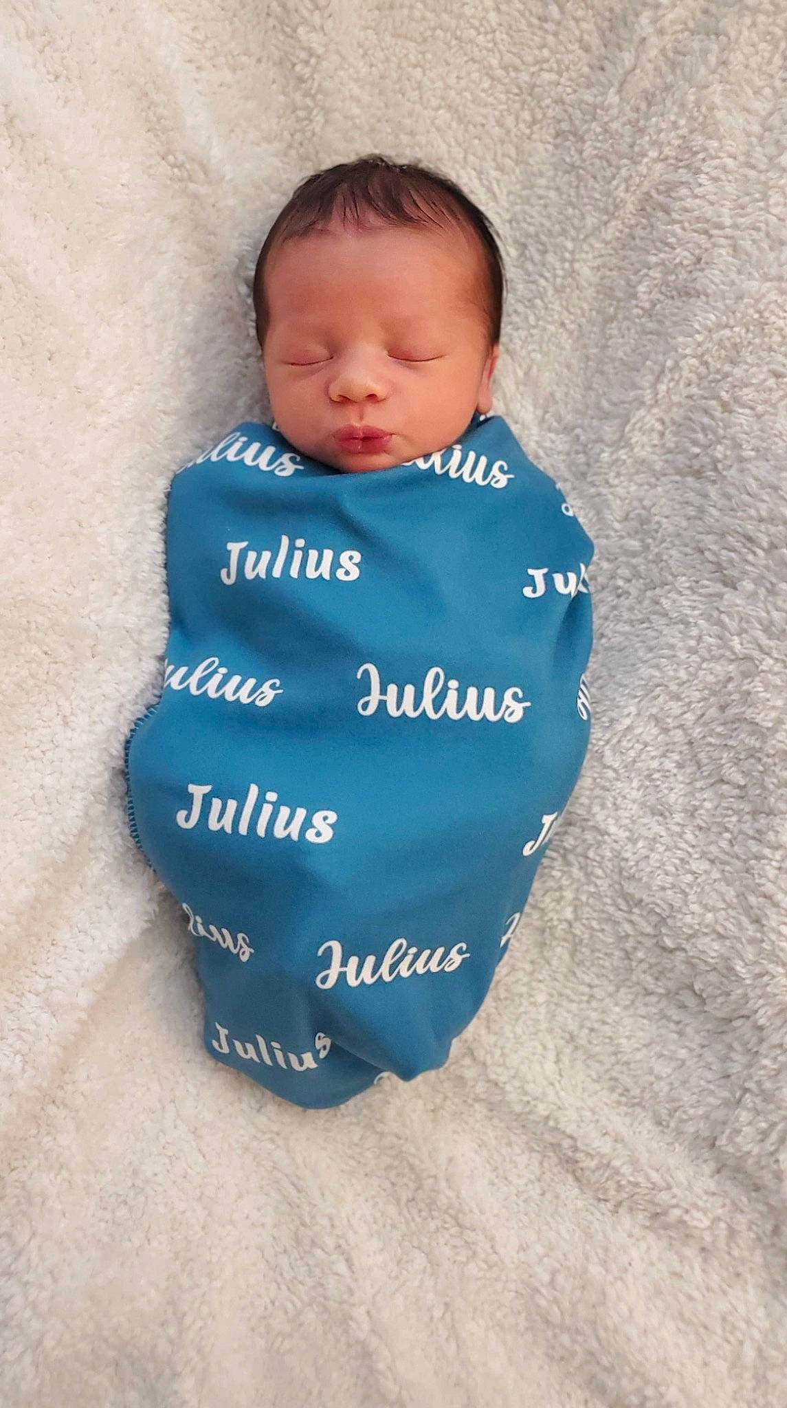Julius is registered to the contest to win money with this photo: azure, baby, baby_products, baby_toddler_clothing, child, circle, comfort, electric_blue, eye, font, pattern, person, sitting, sleeve, t_shirt, toddler