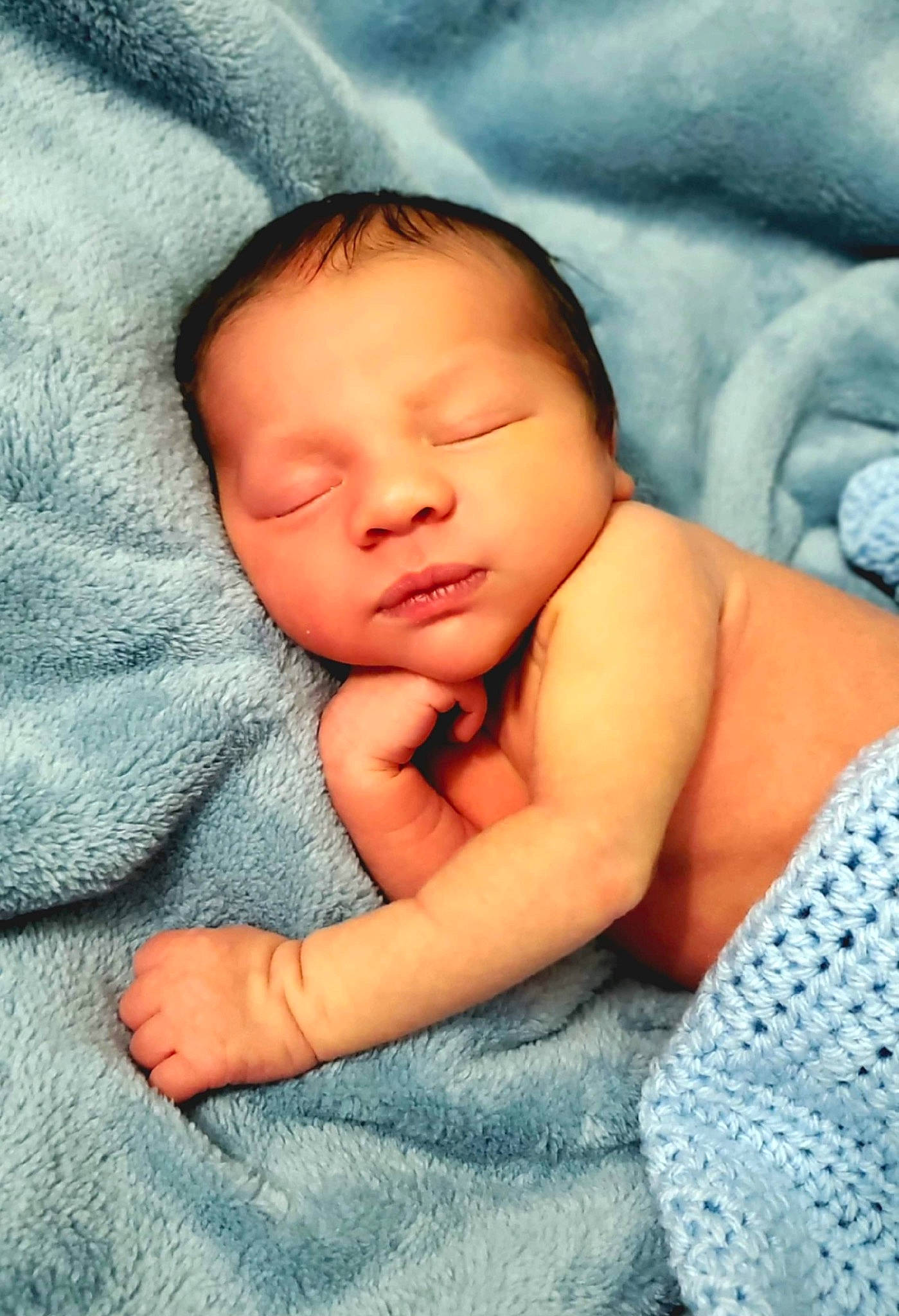 Julius is registered to the contest to win money with this photo: baby, baby_toddler_clothing, bedding, bedtime, blue, cheek, child, close_up, comfort, electric_blue, eye, face, happy, linens, pattern, person, portrait_photography, skin, sleep, thumb