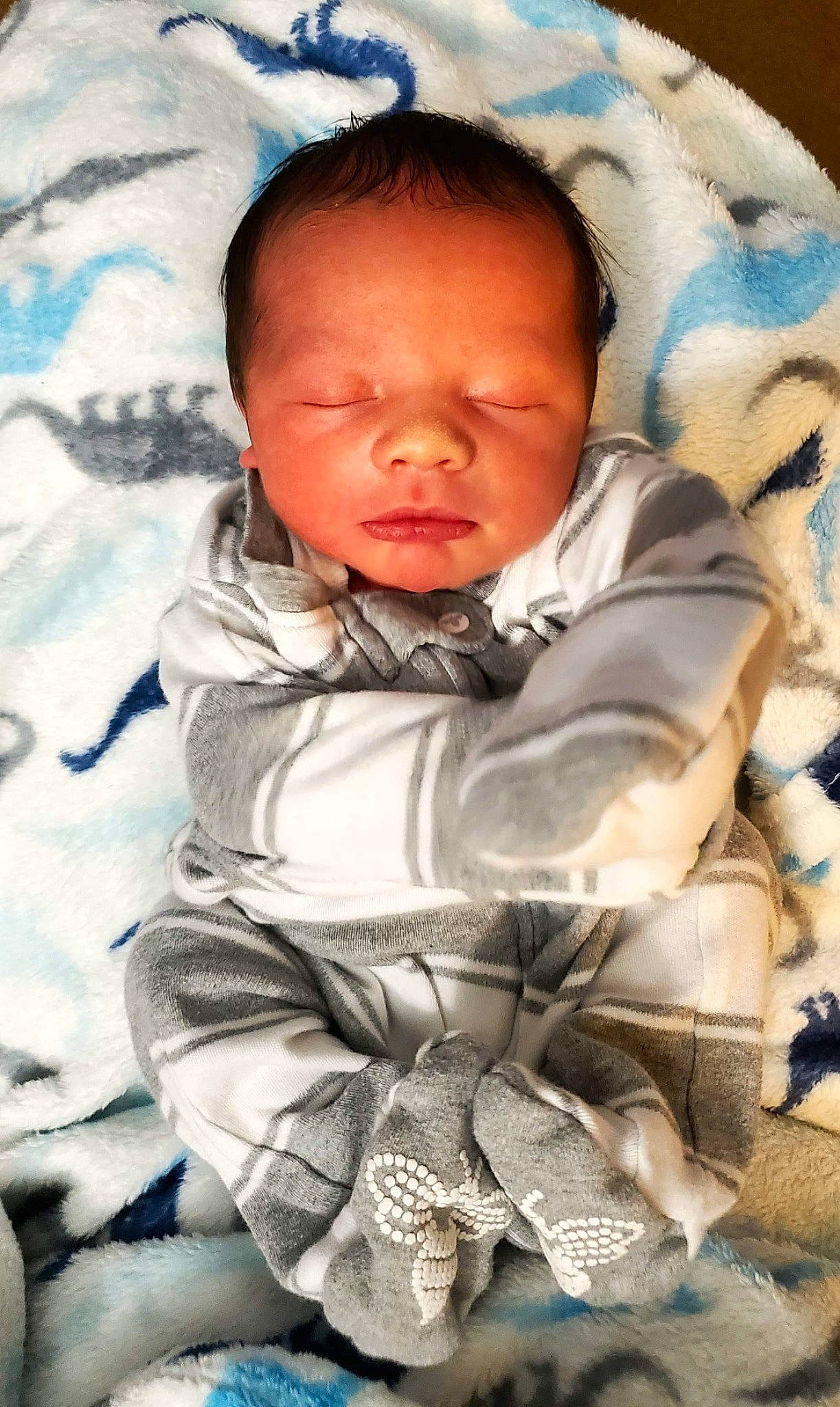 Julius is registered to the contest to win money with this photo: baby, baby_toddler_clothing, cheek, child, comfort, eye, flash_photography, fun, happy, head, linens, nose, pattern, person, portrait_photography, product, sitting, sleeve, textile, toddler