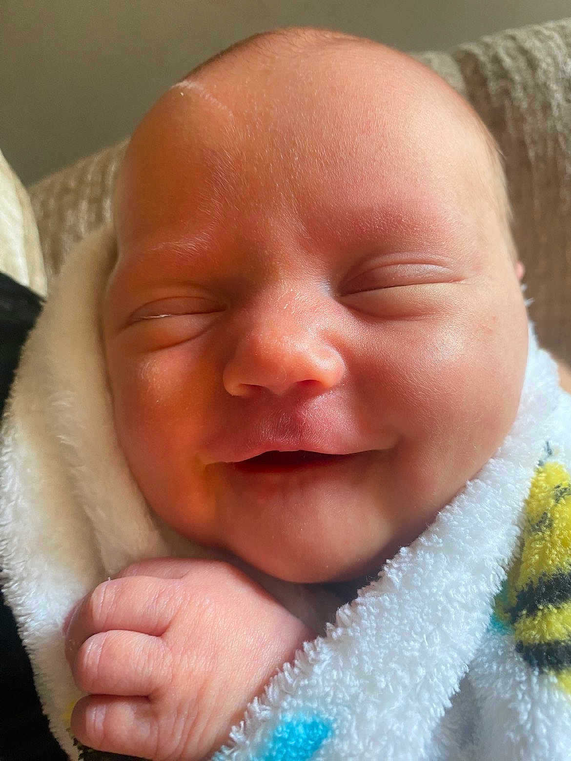 Juniper joined the competition — help win amazing prizes! newborn, baby, smiling, face, hand, blanket, soft, peaceful, infant, cute, wrapped, skin, closeup, sleeping, child, young, indoors, cozy, portrait, warm