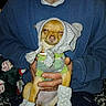 dog, puppy, pet, animal, costume, bonnet, hood, socks, clothing, dressed_up, small_dog, brown_fur, sleepy, portrait, person, hands, indoor, flash_photography, seated, funny
