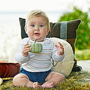 Michael joined the competition — help win amazing prizes! baby, child, pumpkin, furry_rug, pillow, outdoor, curious, blue_eyes, striped_shirt, sitting, barefoot, cute, infant, plush, decor, natural_light, fall_theme, soft_texture, portrait, smiling