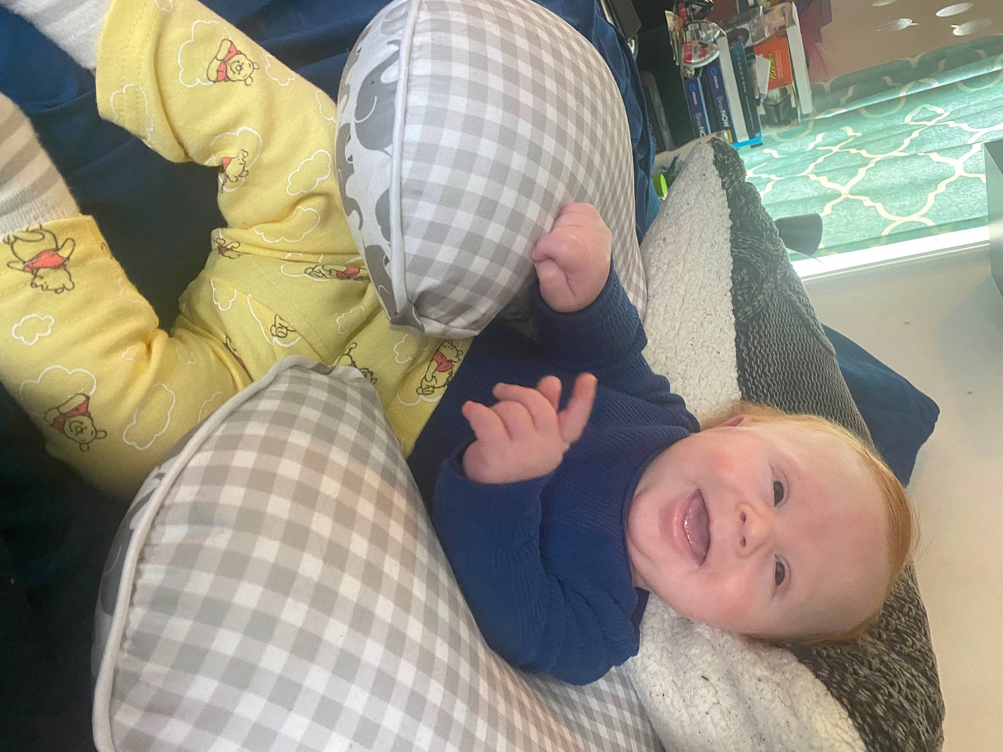 Jace is registered to the contest to win money with this photo: baby, baby_products, child, comfort, finger, flooring, foot, fun, hat, human_leg, joint, lap, leg, pattern, person, room, sitting, smile, textile, thigh