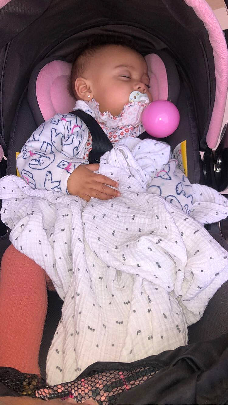 Lynette is registered to the contest to win money with this photo: baby, baby_toddler_clothing, cheek, comfort, facial_expression, finger, headgear, lip, mammal, mouth, neck, nose, organ, person, pink, purple, skin, sleeve, textile, toddler