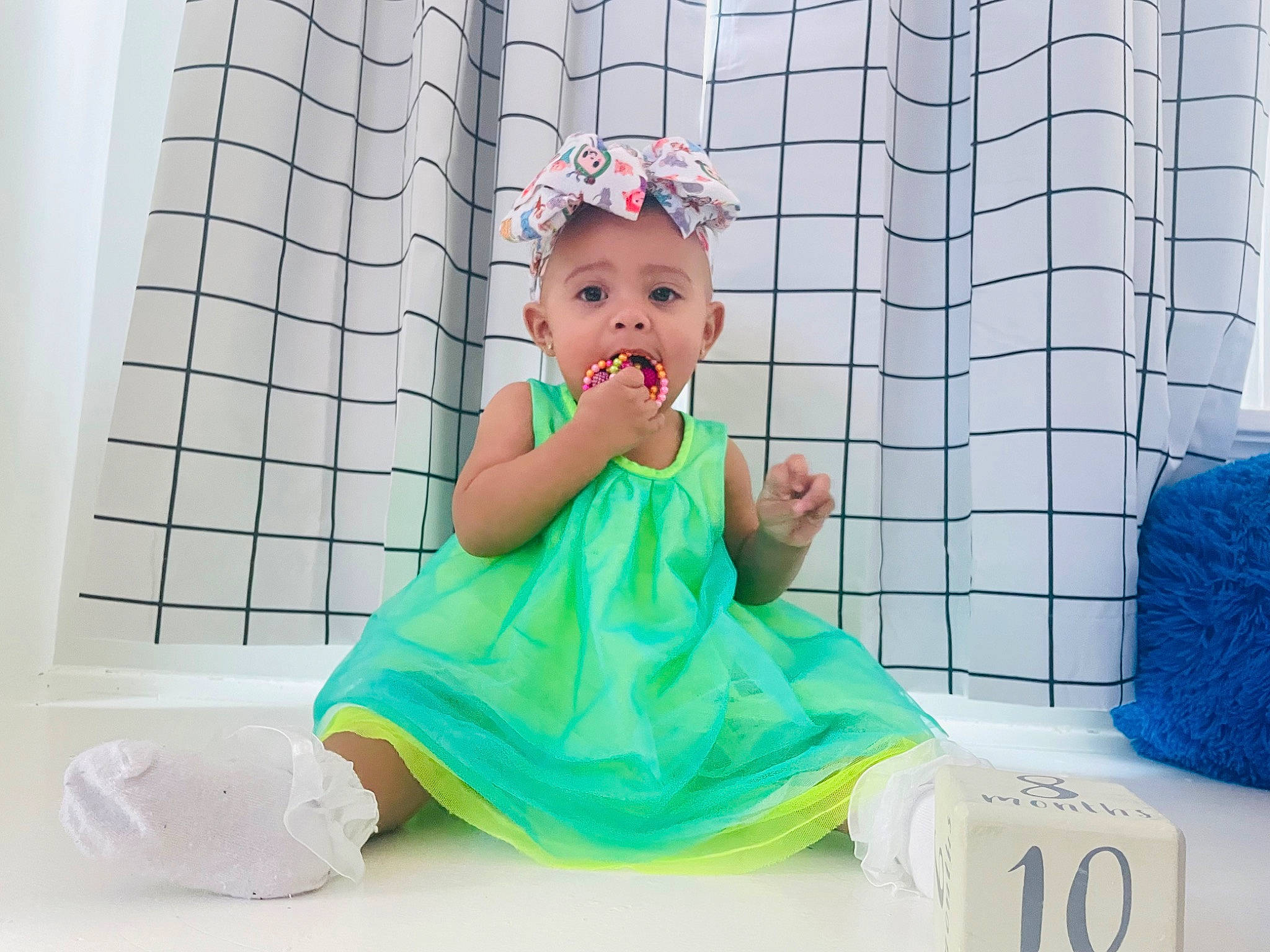 Lynette is registered to the contest to win money with this photo: baby, baby_toddler_clothing, child, comfort, dress, fun, happy, hat, leisure, linens, magenta, party_supply, pattern, person, plastic, play, room, sitting, sleeve, textile