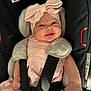 Thea-Rose is registered to the contest to win money with this photo: baby, infant, car_seat, pink_clothing, bow, smile, child, straps, sitting, cute, face, headwear, person, happy, seatbelt, indoors, soft_lighting, newborn, clothing, car_safety