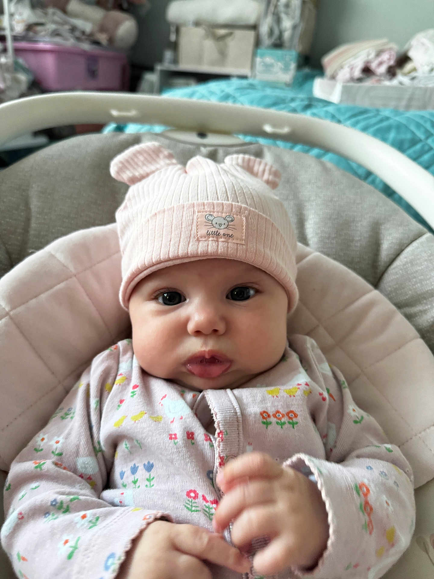 Thea-Rose joined the competition — help win amazing prizes! baby, infant, hat, pink, onesie, floral_pattern, baby_seat, cushion, face, hands, cute, indoors, nursery, soft_lighting, child, apparel, portrait, cozy, expression, clothing