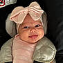 baby, infant, car_seat, pink_bow, smile, face, headwear, clothing, child, seatbelt, cute, portrait, baby_girl, infant_clothing, car_interior, safety, child_seat, closeup, adorable, baby_accessories