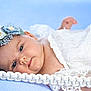 Ilanne participe au concours pour gagner de l'argent avec cette photo : baby, infant, lying_down, blue_blanket, headband, flowers, white_dress, lace, face, eyes, hand, soft_texture, portrait, close_up, cute, newborn, peaceful, skin, child, adorable