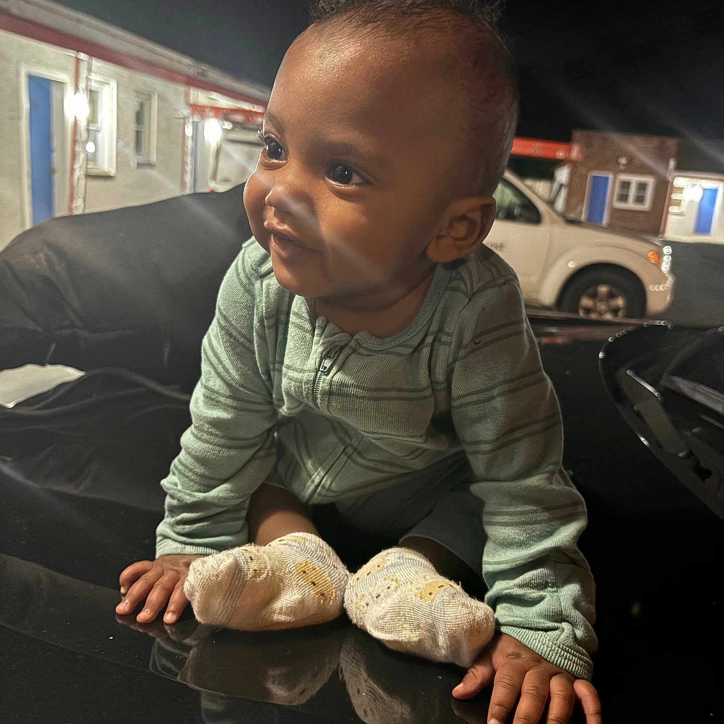 Ja-Pree is registered to the contest to win money with this photo: baby, building, car, child, clothing, curious, door, face, feet, hands, light, night, outdoor, pajamas, person, reflection, smile, socks, vehicle, window