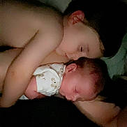 Dallas Reed Wegford is registered to the contest to win money with this photo: baby, child, sleeping, siblings, cuddle, tender, closeup, indoor, soft_light, peaceful, infant, newborn, skin, family, love, quiet, rest, bedtime, portrait, sleep