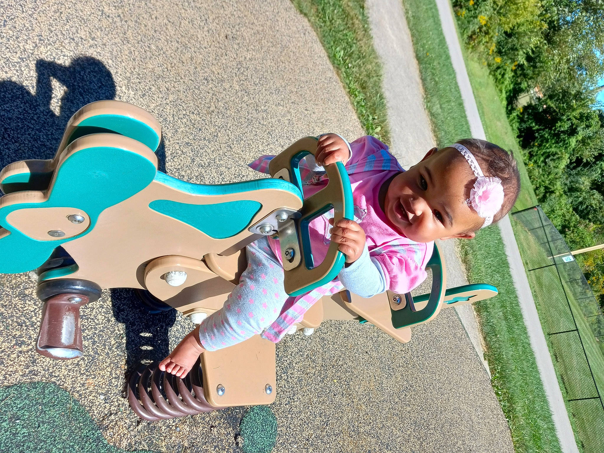 Mckenna is registered to the contest to win money with this photo: baby_toddler_clothing, child, city, cool, eyewear, fun, grass, happy, joy, leisure, magenta, people_in_nature, person, plant, play, playground, recreation, sitting, sunglasses, t_shirt