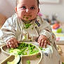 baby, child, high_chair, bib, green_food, messy, feeding, cute, indoor, food, plate, hands, face, eyes, smile, clothing, person, infant, cucumber, meal
