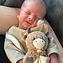 arm, baby, blanket, child, clothing, comfort, cow_toy, cozy, cuddly, cute, indoor, infant, peaceful, plush_toy, portrait, resting, sleeping, smiling, soft_texture, toddler