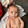 Leah is registered to the contest to win money with this photo: baby, infant, child, naked_torso, blanket, couch, clothing, hand, skin, blue_eyes, face, person, indoors, soft_light, expression, curly_hair, fingers, comfort, seated, young