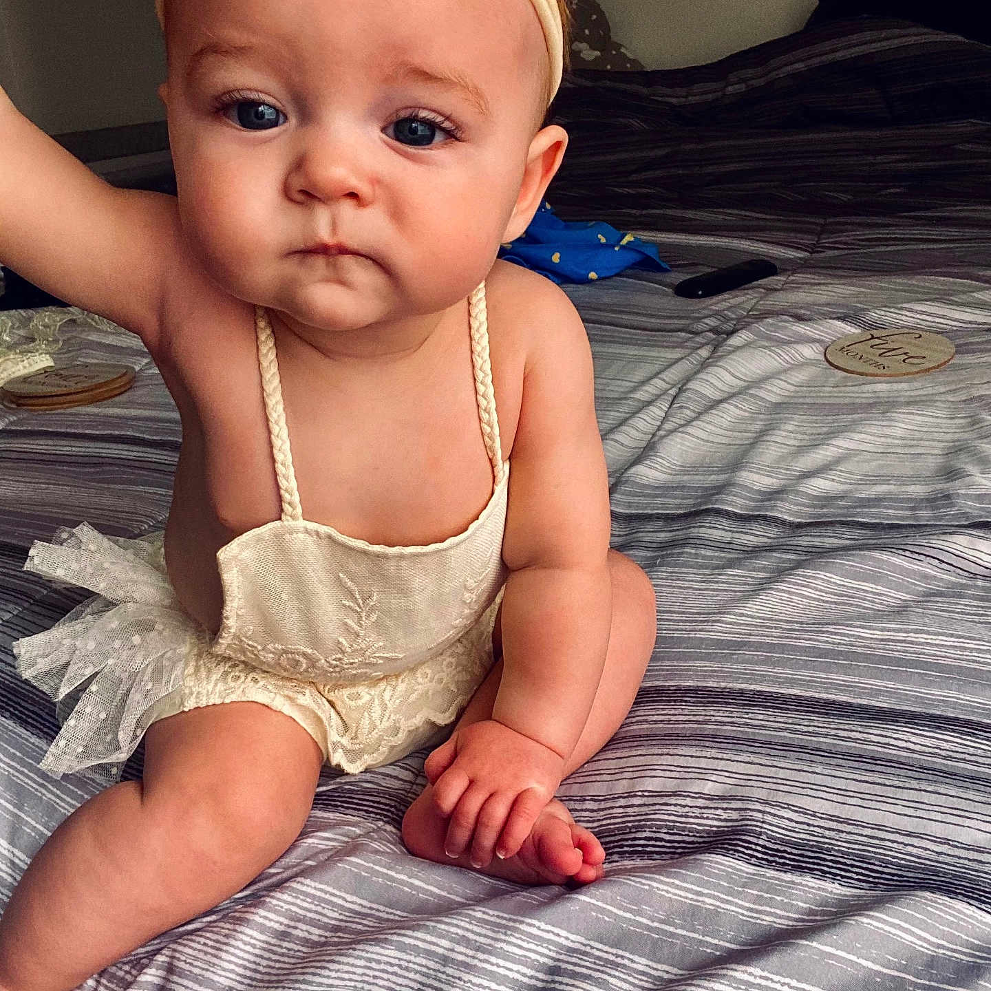 Leah joined the competition — help win amazing prizes! baby, infant, child, headband, lace, bed, bedspread, striped, clothing, cute, sitting, skin, hand, foot, indoors, portrait, expression, person, young, room