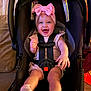 baby, infant, child, car_seat, headband, bow, smile, laughing, happy, harness, seat, socks, legs, portrait, indoor, pink, adorable, cozy, face, accessory