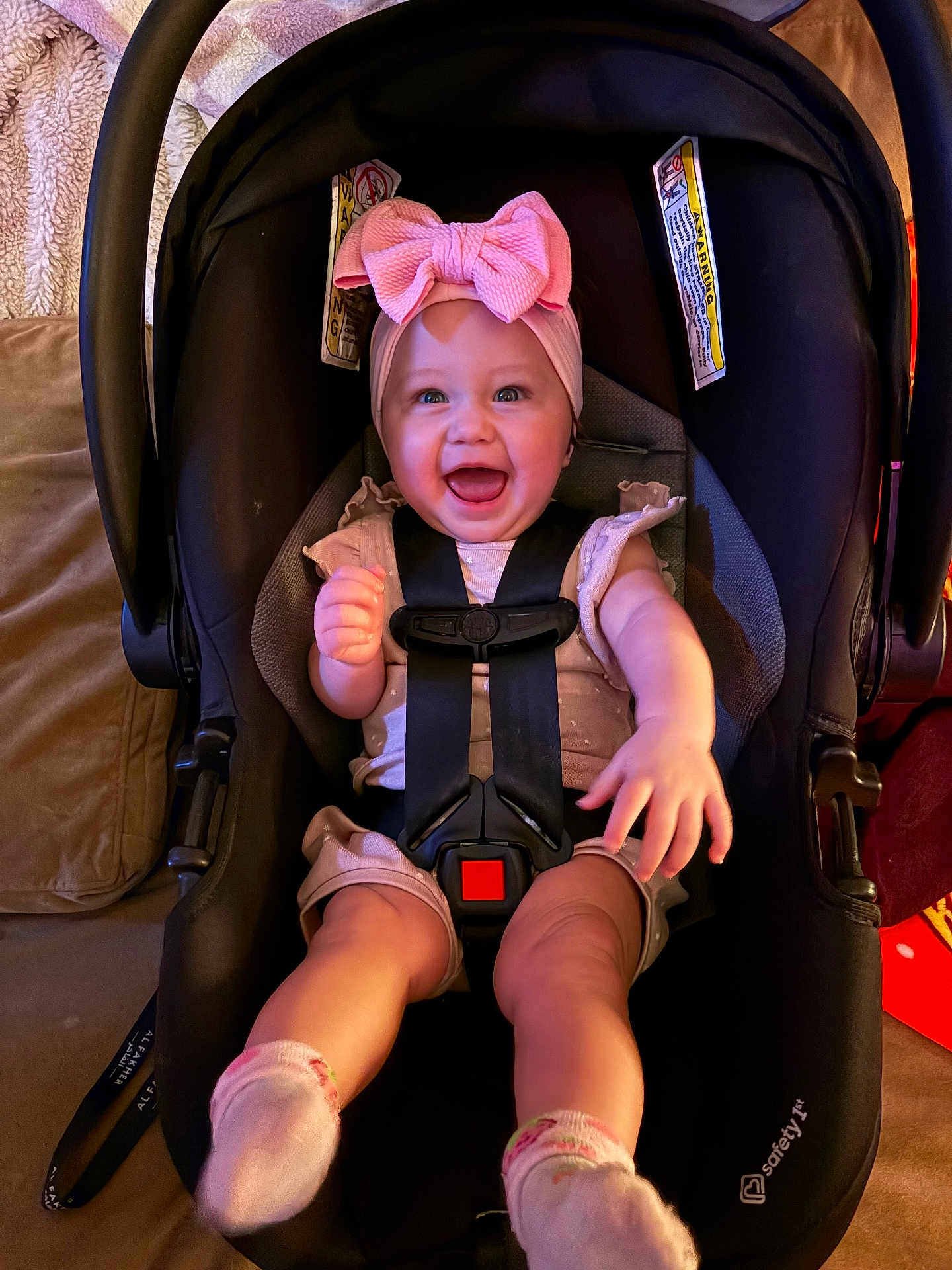 Lucelia is registered to the contest to win money with this photo: baby, infant, child, car_seat, headband, bow, smile, laughing, happy, harness, seat, socks, legs, portrait, indoor, pink, adorable, cozy, face, accessory
